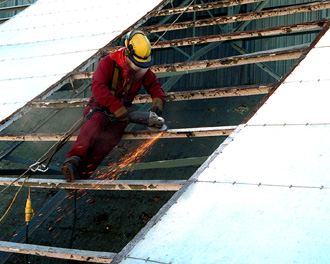 SHAL engineer cleaning the surface of the backing structure