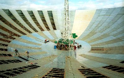 View of workers replacing panels inside the dish