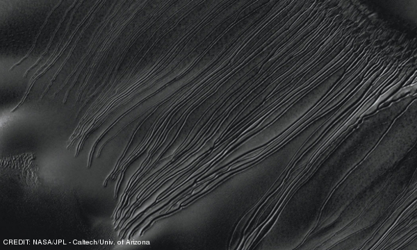 Dry ice tracks on Mars: Several types of downhill flow features have been observed on Mars. This image from the High Resolution Imaging Science Experiment (HiRISE) camera on NASA's Mars Reconnaissance Orbiter is an example of a type called June 2013 Extra